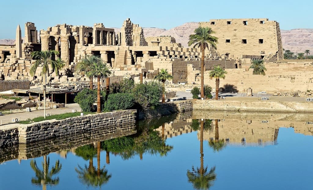 Karnak Temple Great Hypostyle Hall at dawn — 134 sandstone columns rising through early mist, East Bank Luxor Egypt