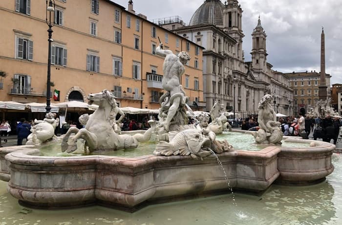 The Fountain of Neptune in Piazza Navona with the church of Sant'Agnese in Agone and the square's baroque architecture — a key stop on any private walking tour of Rome's historic centre