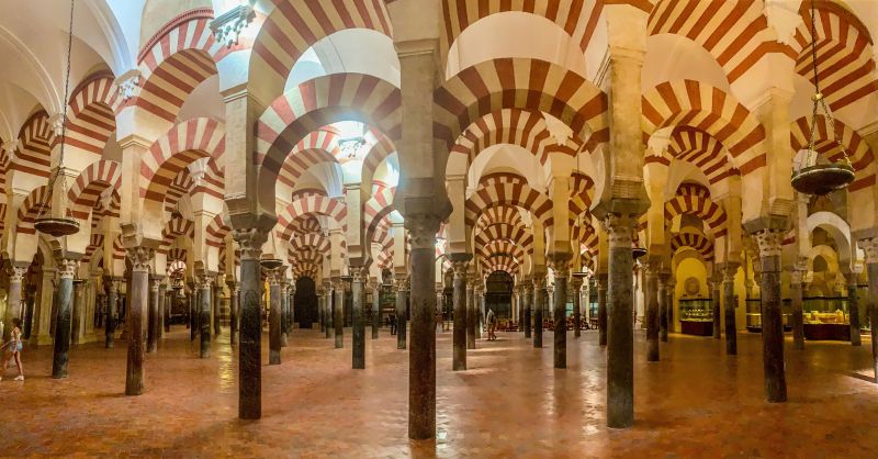 Red and white striped arches inside the Mezquita-Catedral of Córdoba — day trip from Málaga