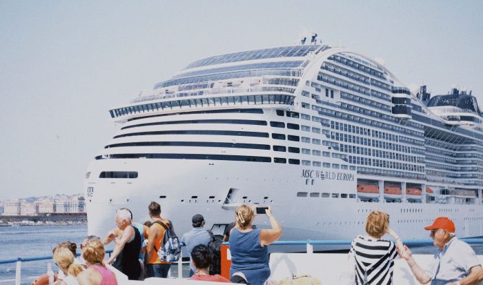 Cruise ship berthed at the Hamdan bin Mohammed Cruise Terminal in Port Rashid Dubai with shore excursion vehicles waiting