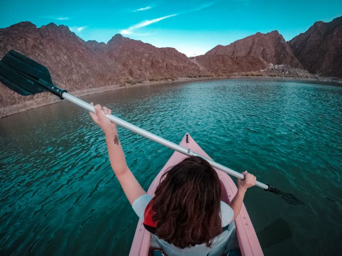 Kayaks on the turquoise water of the Hatta Dam reservoir surrounded by the Hajar Mountains on a day trip from Dubai