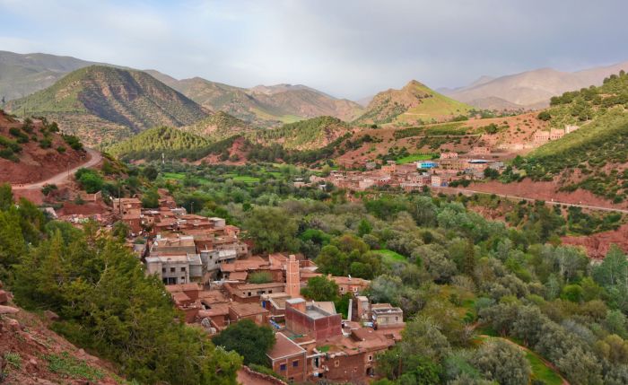 Stone Amazigh village and terraced fields below the snow-topped peaks of the High Atlas near Imlil