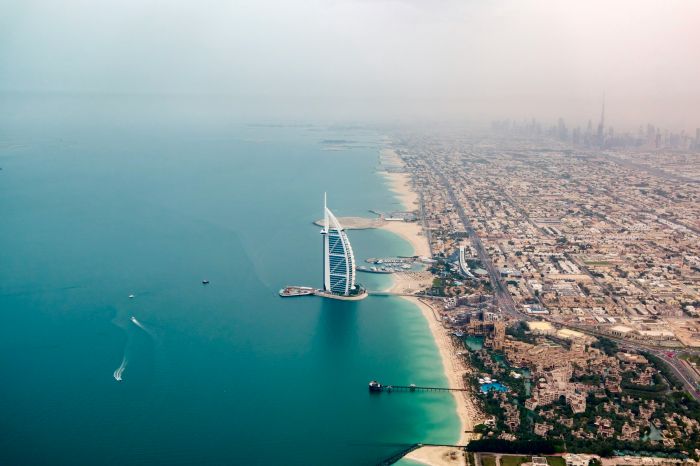 Luxury private tour helicopter flying over Palm Jumeirah and the Dubai skyline