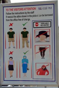 Official sign at the entrance to Hagia Sophia showing accepted and refused clothing for visitors