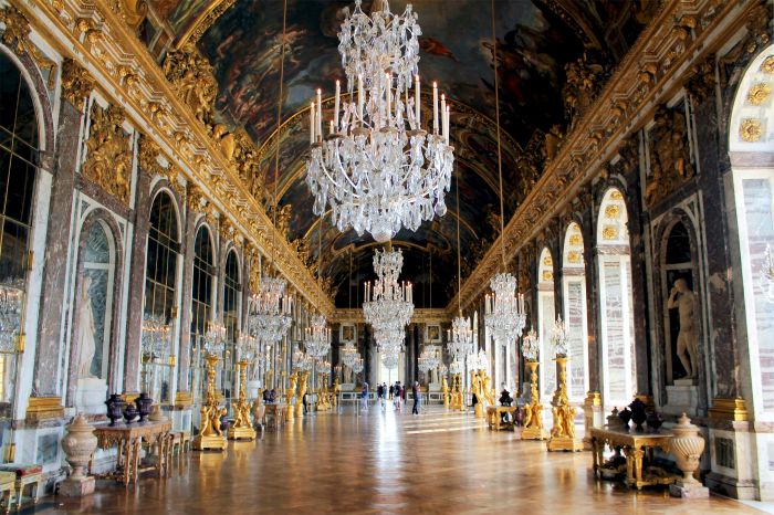 The Hall of Mirrors in the Palace of Versailles with its chandeliers and painted ceiling